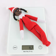 Resin doll peeks at bent Christmas elf doll, black felt doll Snoop on a Stoop