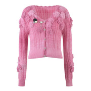 Pink knitted sweater with a three-dimensional floral design and cardigan sweater